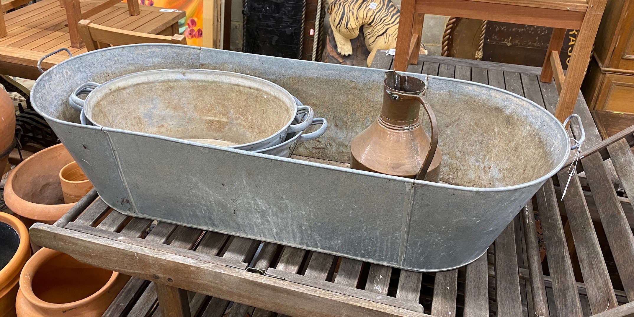 Three oval galvanised containers and a Turkish copper pot, largest length 135cm